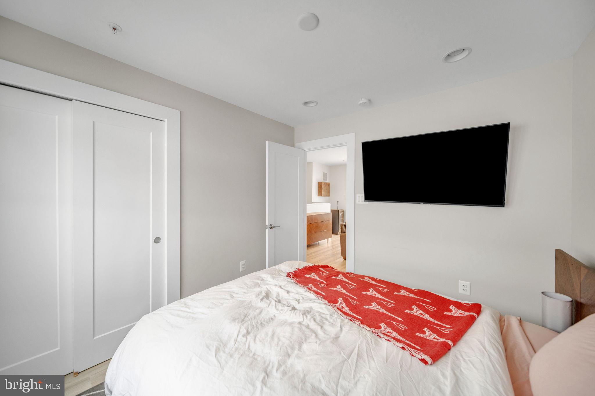 11326 Emerald Park Road Potomac, MD 20854 - Photo 23 of 40 a bedroom with a bed and a flat screen tv