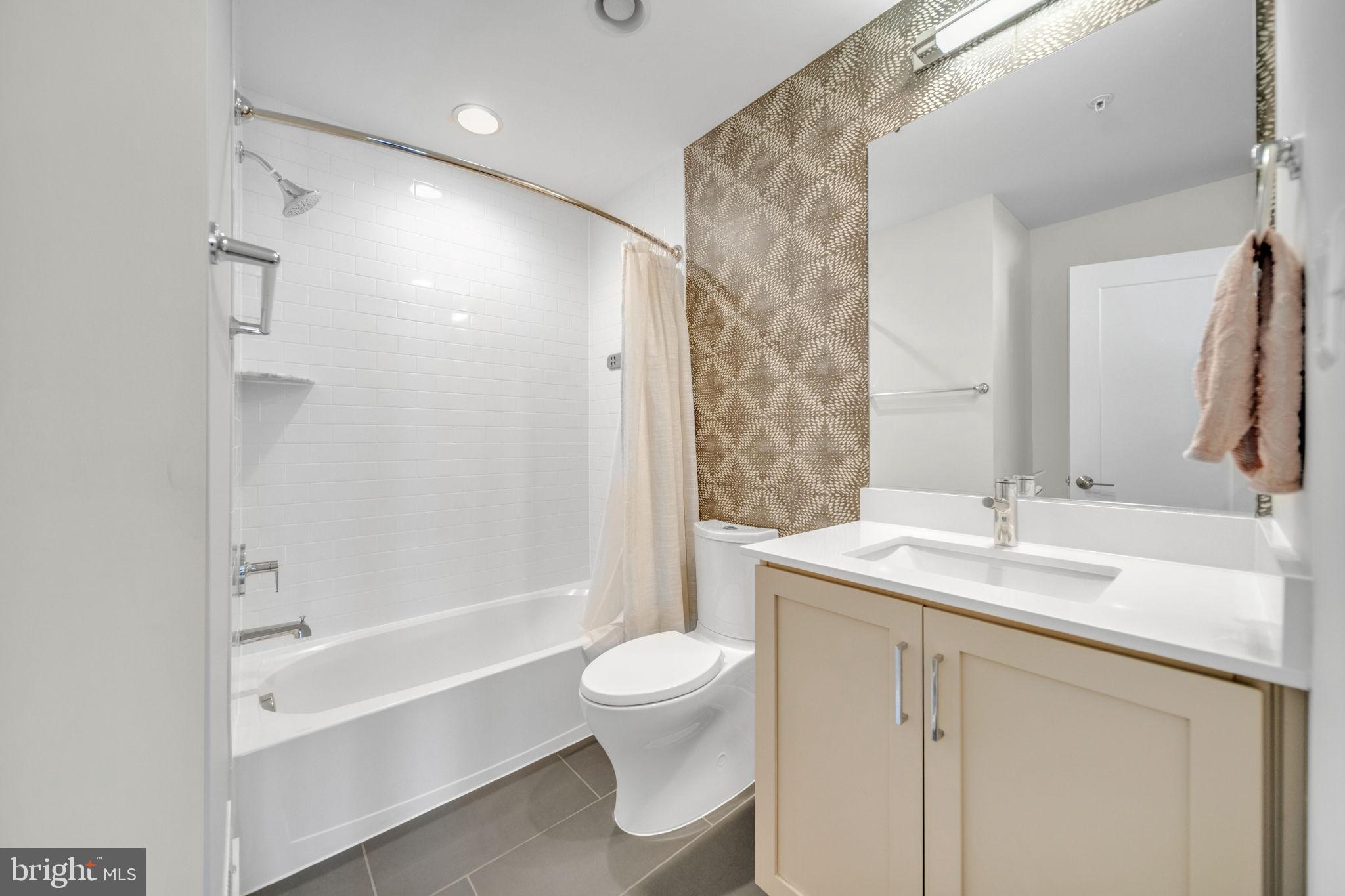 11326 Emerald Park Road Potomac, MD 20854 - Photo 26 of 40 a bathroom with a granite countertop sink toilet and shower