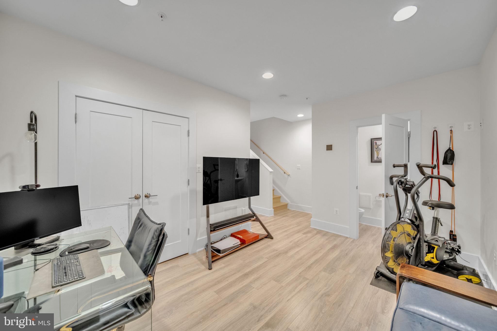 11326 Emerald Park Road Potomac, MD 20854 - Photo 28 of 40 a view of a workspace with furniture and a flat screen tv
