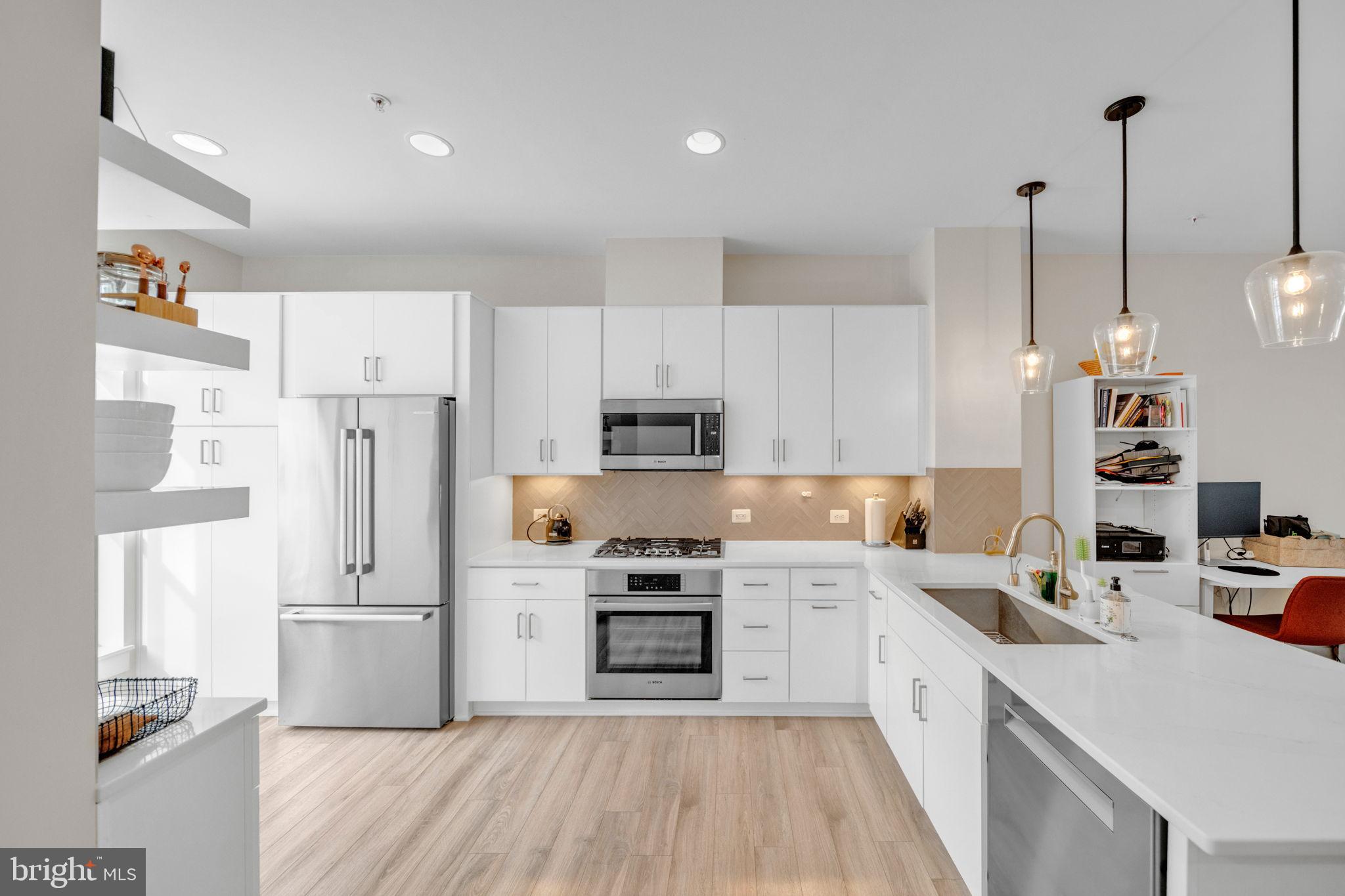 11326 Emerald Park Road Potomac, MD 20854 - Photo 7 of 40 a kitchen with stainless steel appliances a refrigerator sink and cabinets
