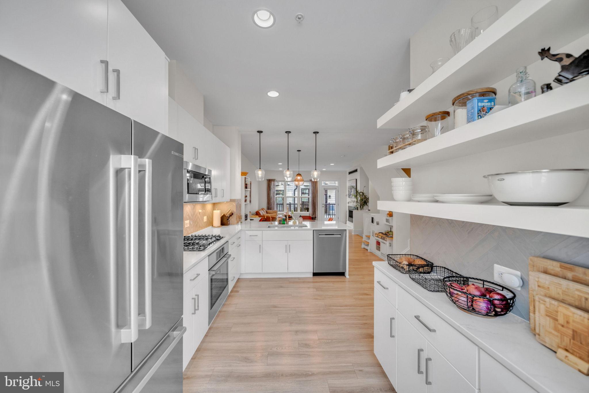 11326 Emerald Park Road Potomac, MD 20854 - Photo 8 of 40 a kitchen with stainless steel appliances granite countertop a refrigerator a stove and a sink