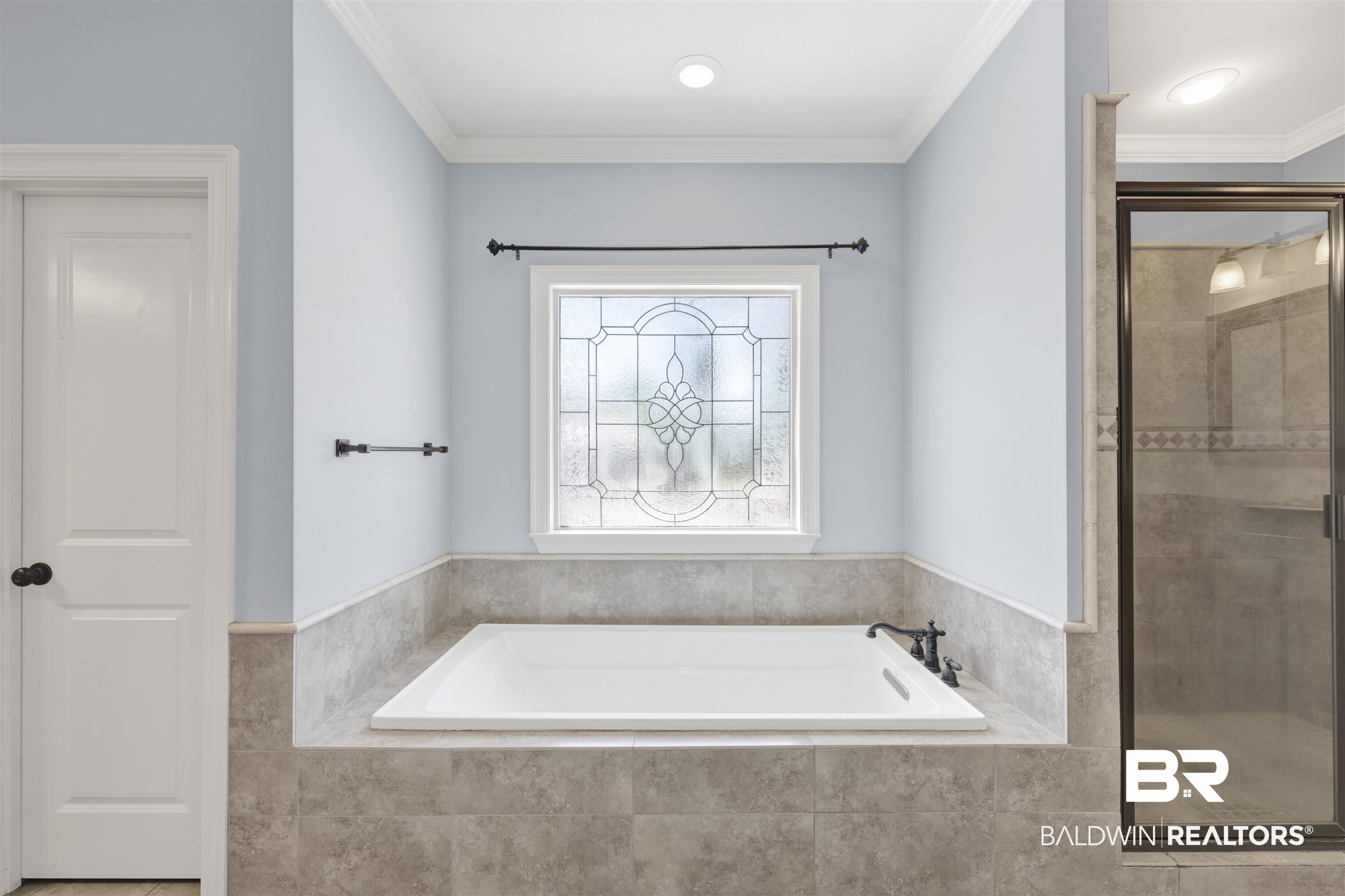 12944 Anna's Way Stapleton, AL 36578 - Photo 53 of 64 Built-in soaking tub with tile surround, stained glass window, and a separate glass-enclosed shower featuring tile accents