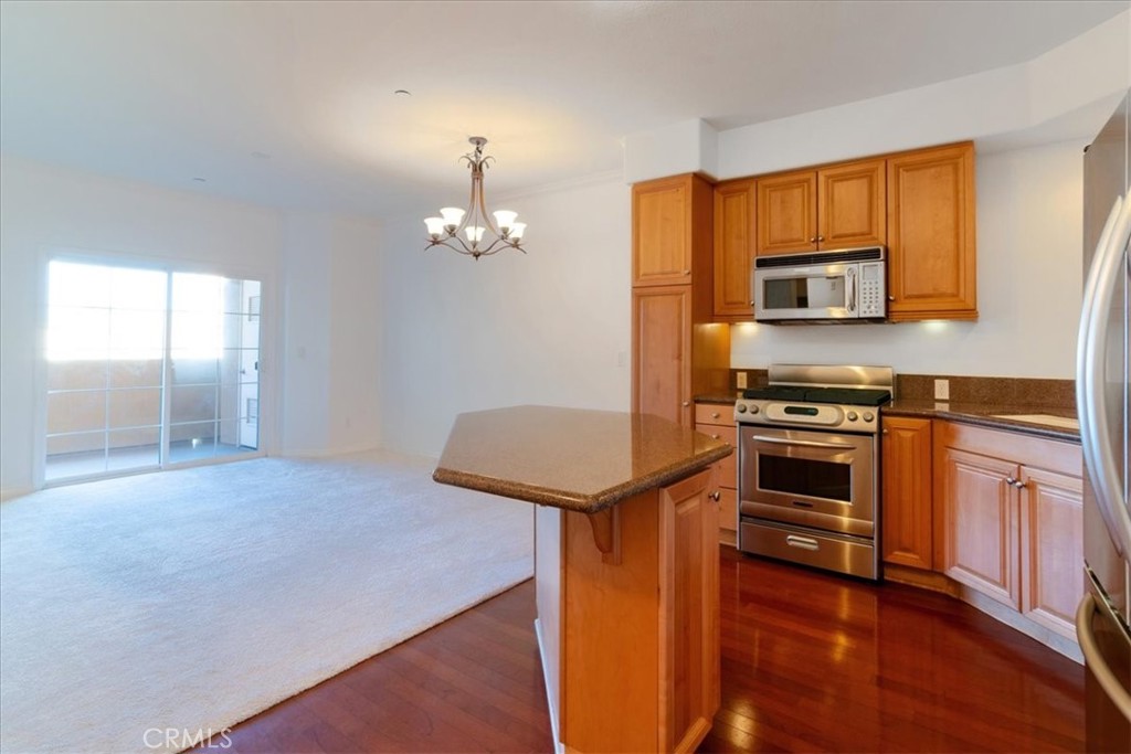 21345 Hawthorne Boulevard, Unit 217 Torrance, CA 90503 - Photo 4 of 41 a kitchen with stainless steel appliances a stove top oven and a refrigerator