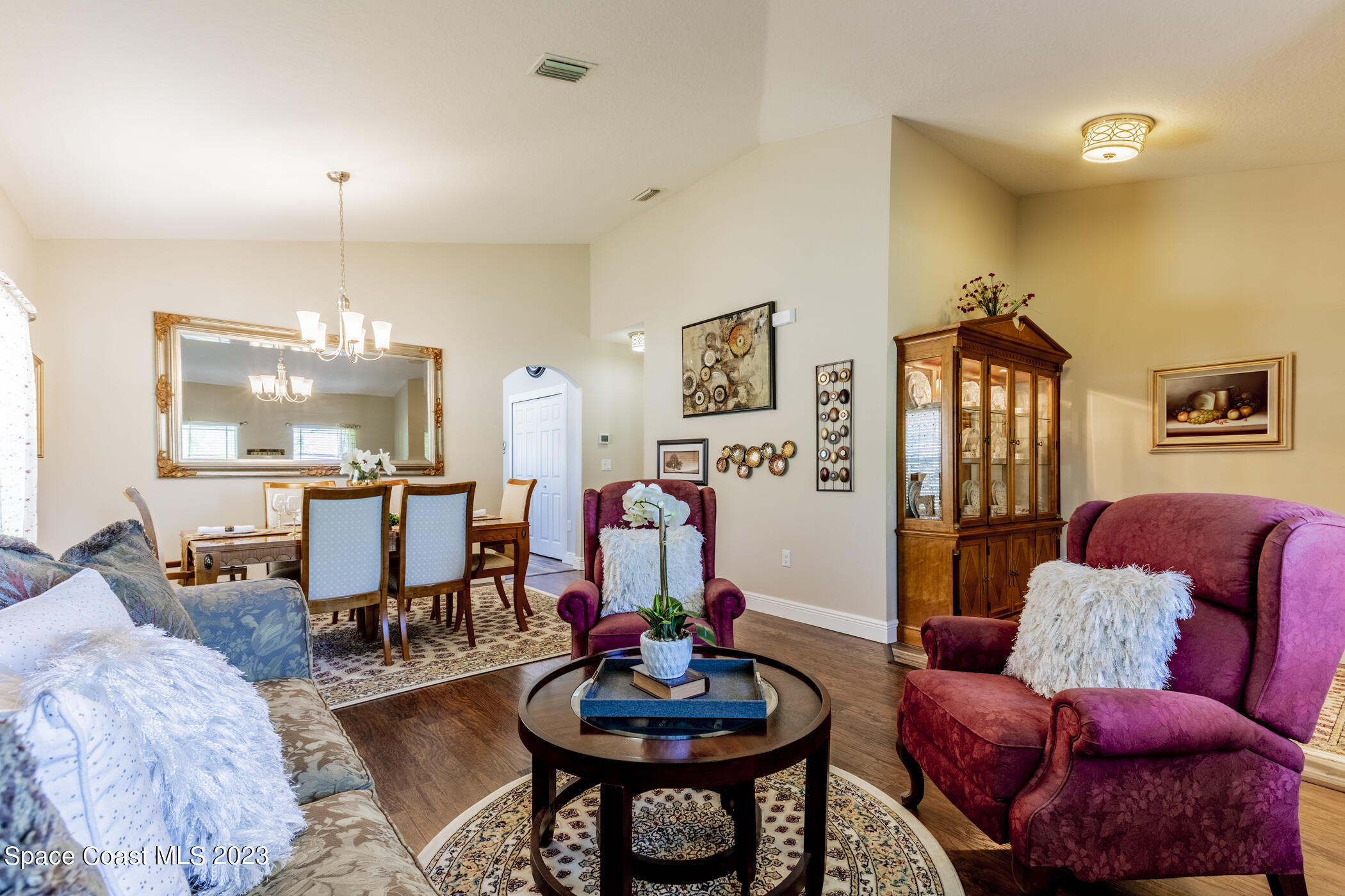 2995 Louetta Circle Melbourne, FL 32901 - Photo 11 of 42 a living room with furniture and a chandelier