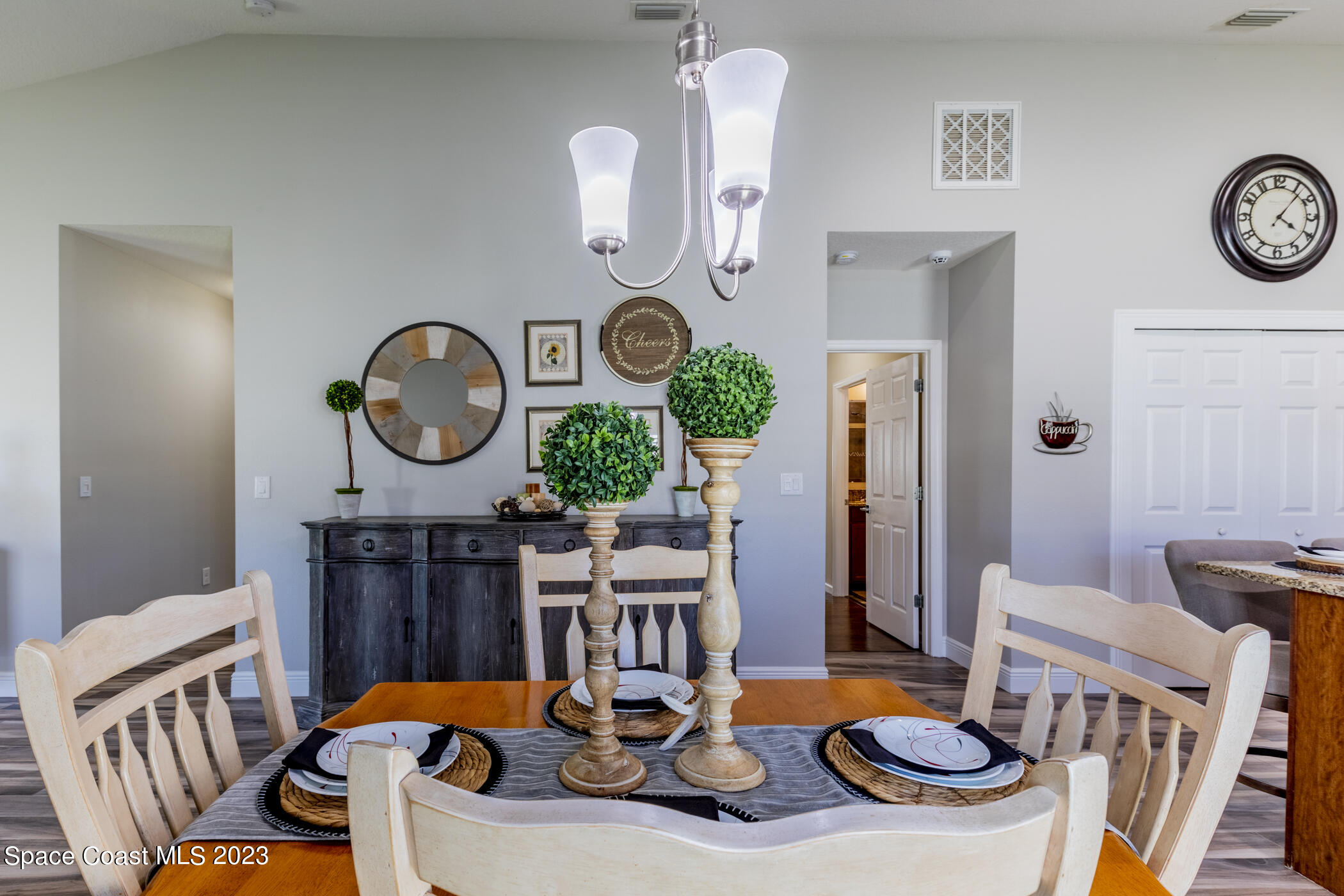 2995 Louetta Circle Melbourne, FL 32901 - Photo 22 of 42 a living room with furniture a clock on wall and a table