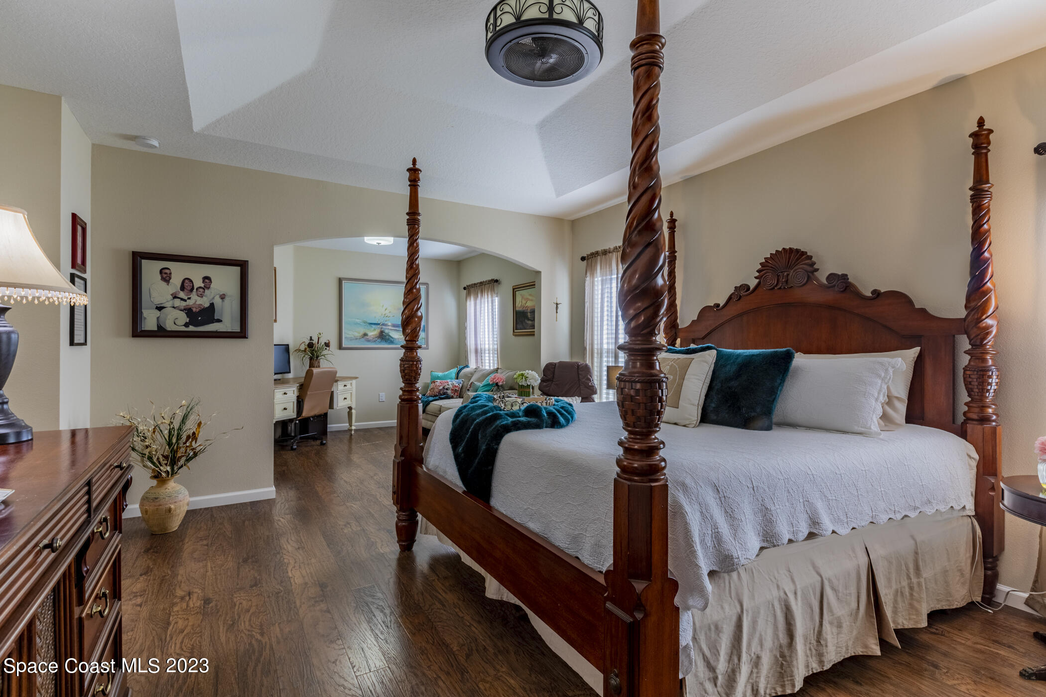2995 Louetta Circle Melbourne, FL 32901 - Photo 26 of 42 a bedroom with a bed and a chandelier