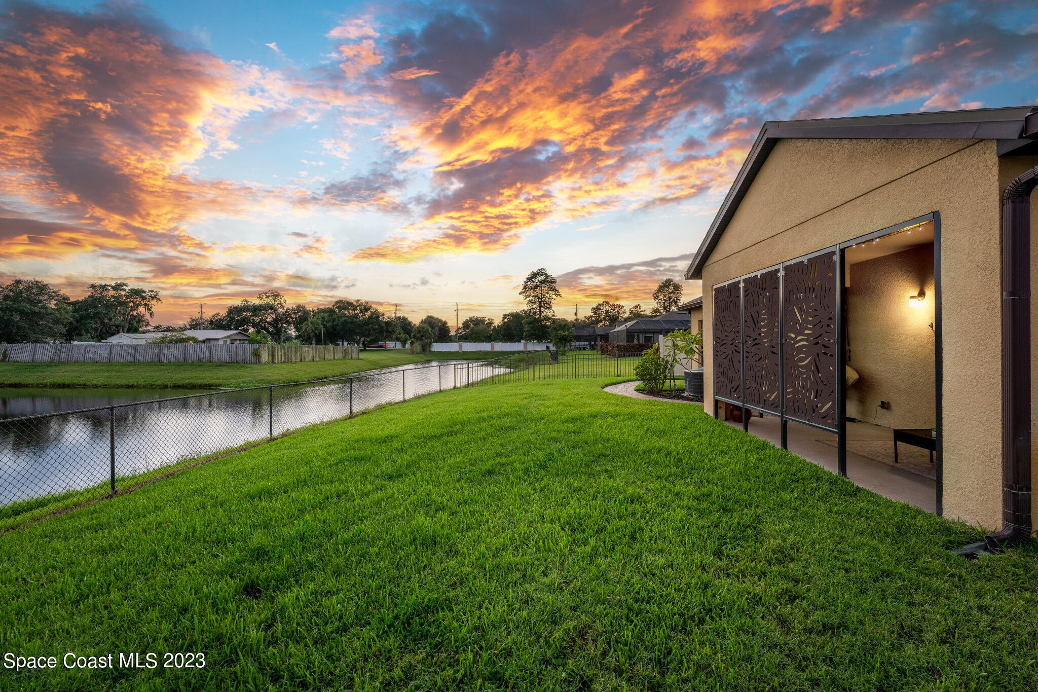 2995 Louetta Circle Melbourne, FL 32901 - Photo 37 of 42 a backyard of a house with lots of green space and lake view