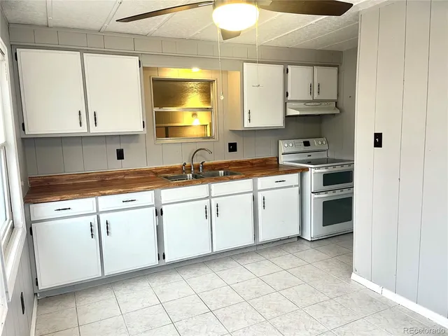a kitchen with granite countertop a sink stainless steel appliances and cabinets
