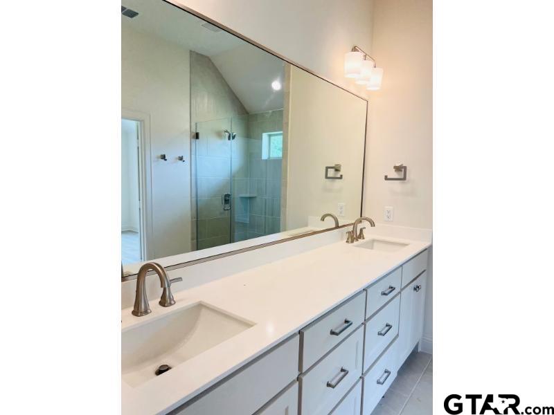 2983 Guinn Farms Road Tyler, TX 75707 - Photo 11 of 22 a bathroom with a sink and a mirror