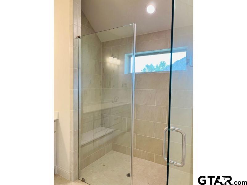 2983 Guinn Farms Road Tyler, TX 75707 - Photo 12 of 22 a bathroom with a glass shower door