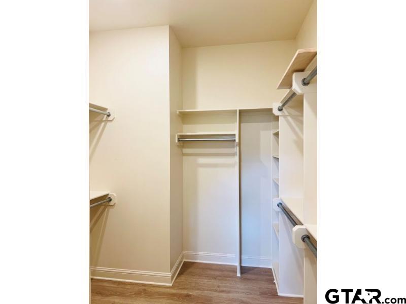 2983 Guinn Farms Road Tyler, TX 75707 - Photo 14 of 22 a view of walk in closet with empty racks