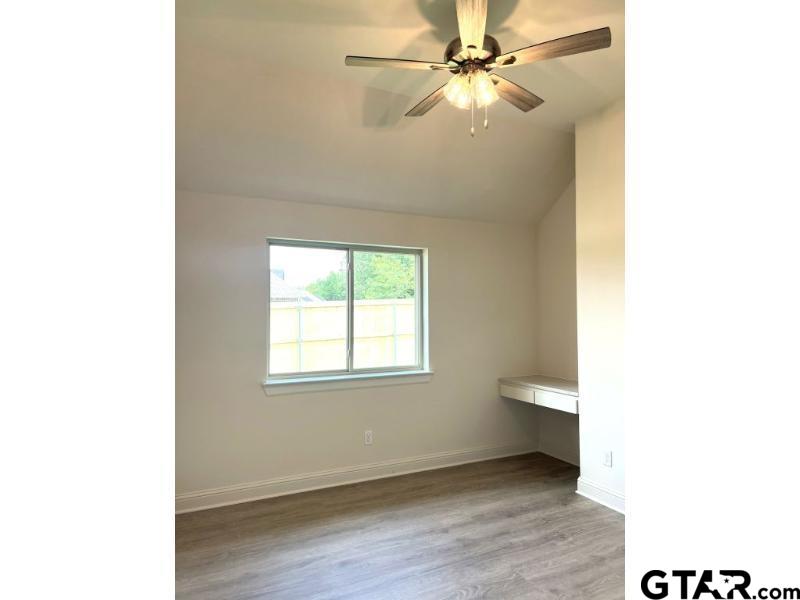2983 Guinn Farms Road Tyler, TX 75707 - Photo 18 of 22 a view of an empty room with a window and a ceiling fan