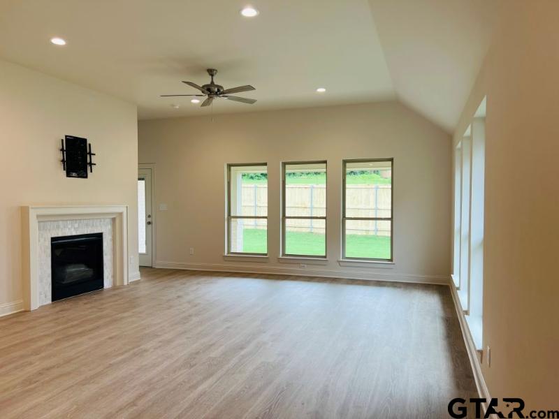 2983 Guinn Farms Road Tyler, TX 75707 - Photo 8 of 22 a view of an empty room with a fireplace and a window