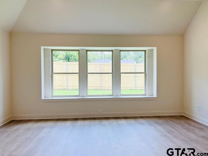 2983 Guinn Farms Road Tyler, TX 75707 - Photo 10 of 22 an empty room with wooden floor and windows
