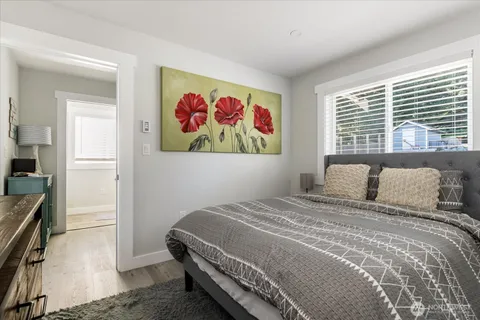 a bedroom with a bed and a painting on the wall