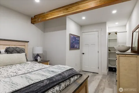 a bedroom with a bed and a painting on the wall