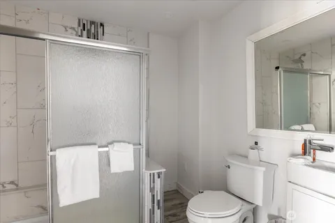 a bathroom with a sink a toilet and mirror