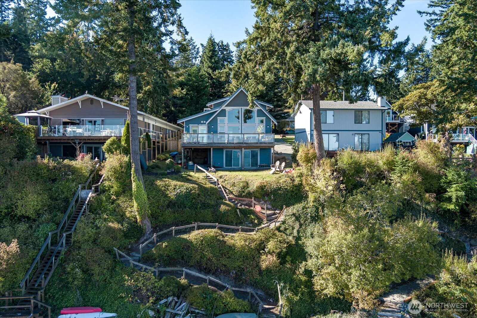 159 South Harrington Lagoon Road Coupeville, WA 98239 - Photo 32 of 37 a front view of a house with a yard and large trees