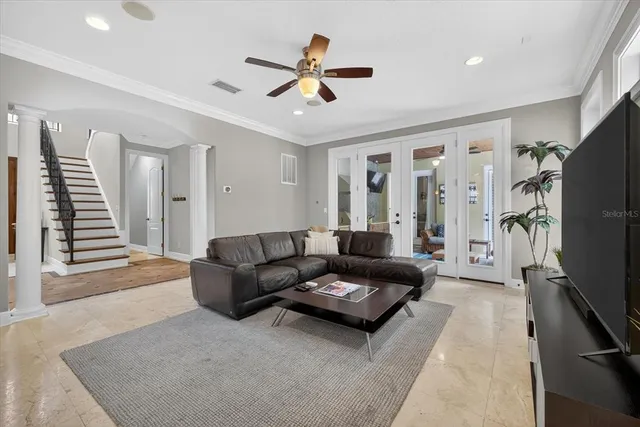 a living room with furniture and kitchen view