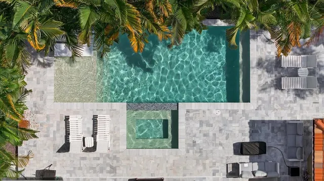 a view of a house with backyard porch and sitting area