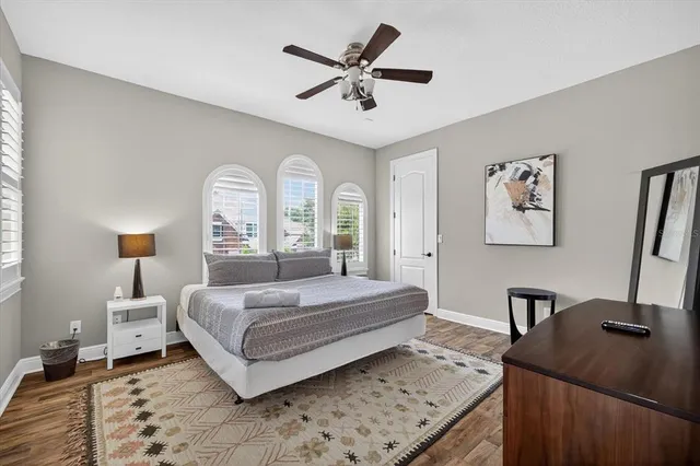 a bedroom with a bed and a ceiling fan
