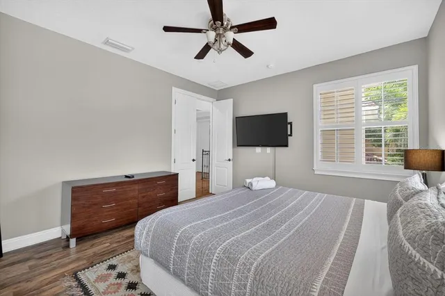 a bedroom with bed and a chandelier