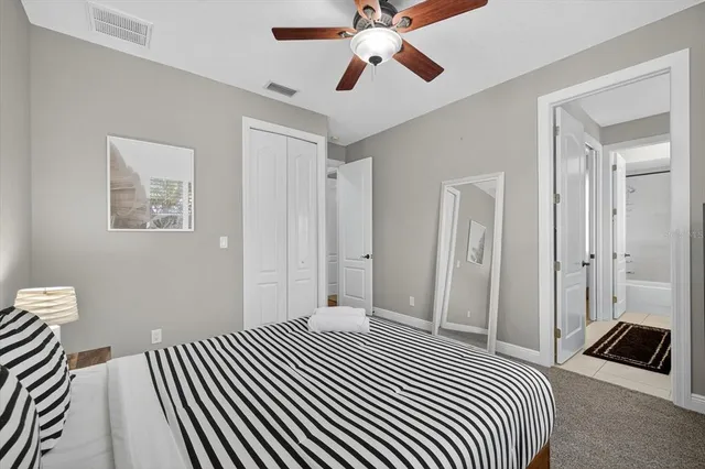 a bathroom with a granite countertop sink a large mirror and a bathtub next to a window