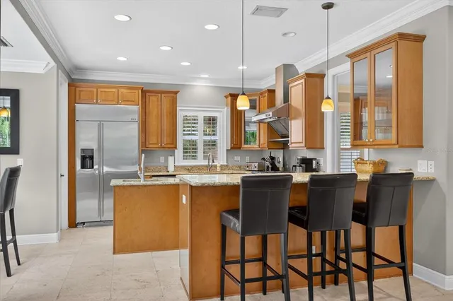 a large kitchen with cabinets table and chairs