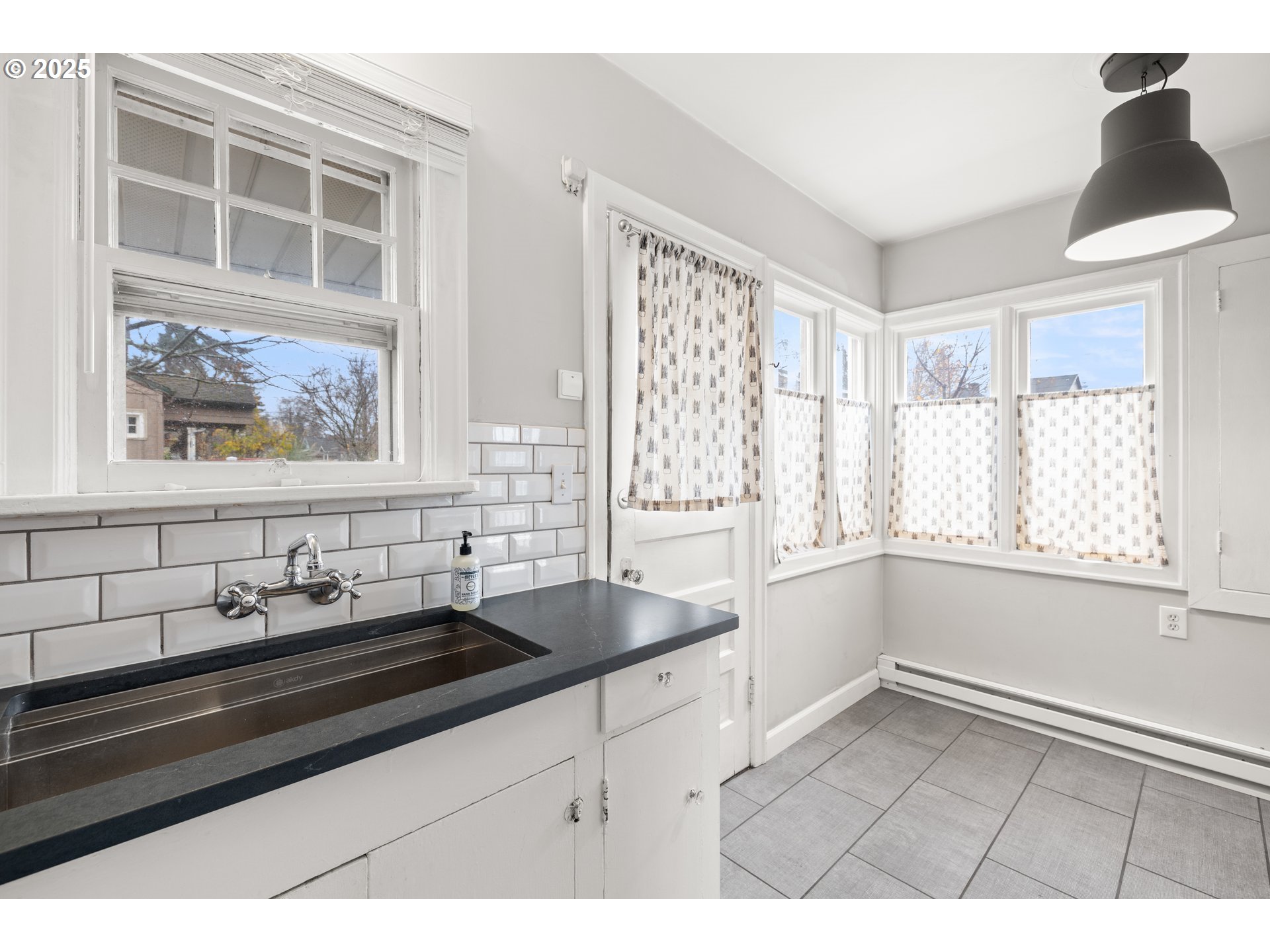 7104 Southeast Tolman Street Portland, OR 97206 - Photo 14 of 34 a kitchen with a sink and a window