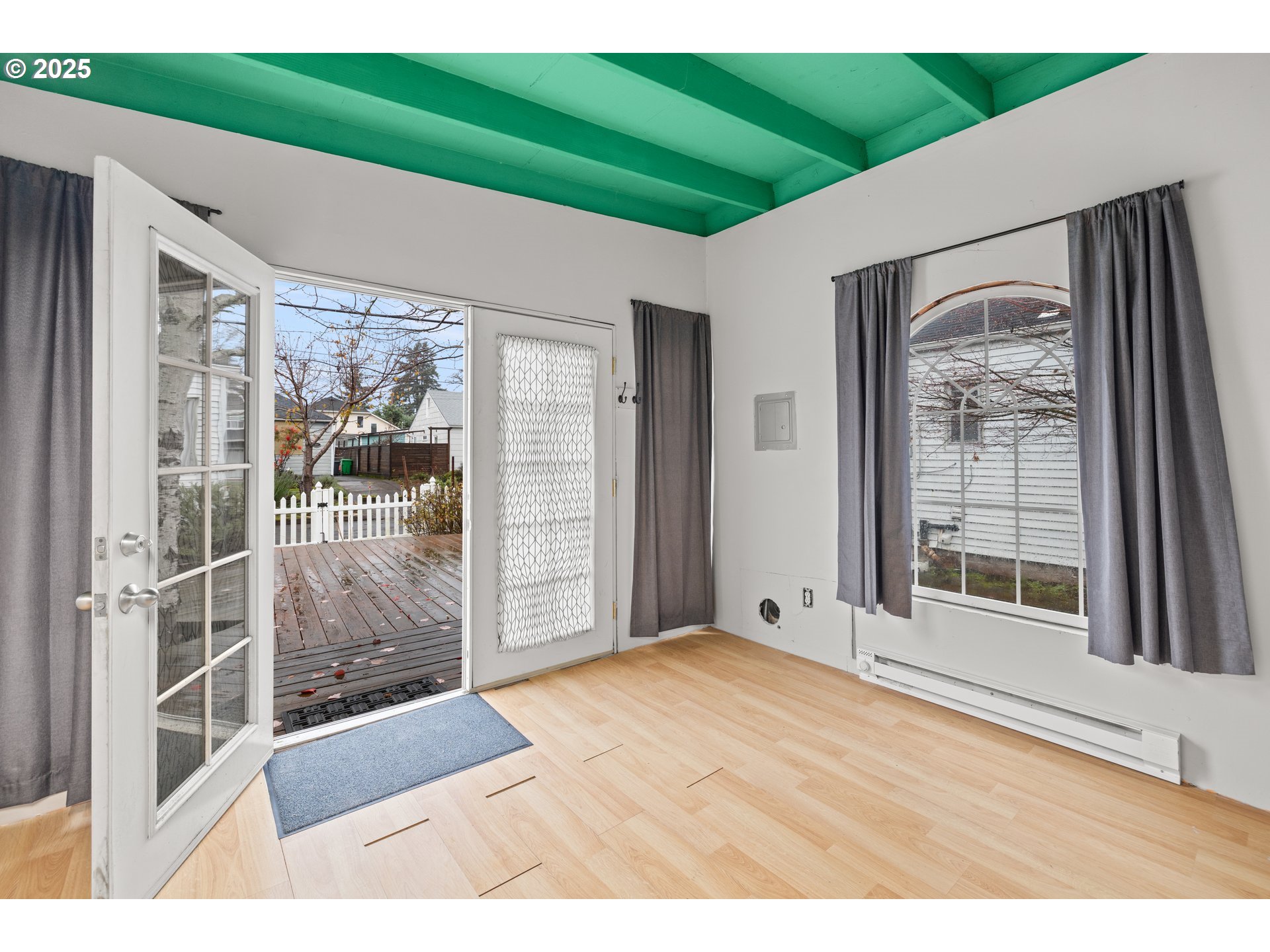 7104 Southeast Tolman Street Portland, OR 97206 - Photo 25 of 34 a view of an empty room with window and wooden floor
