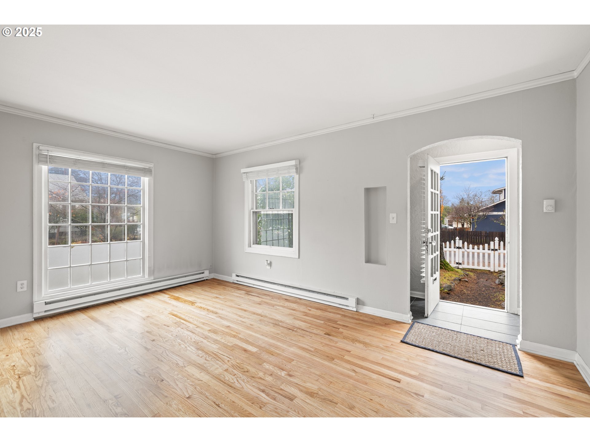 7104 Southeast Tolman Street Portland, OR 97206 - Photo 6 of 34 an empty room with wooden floor and windows