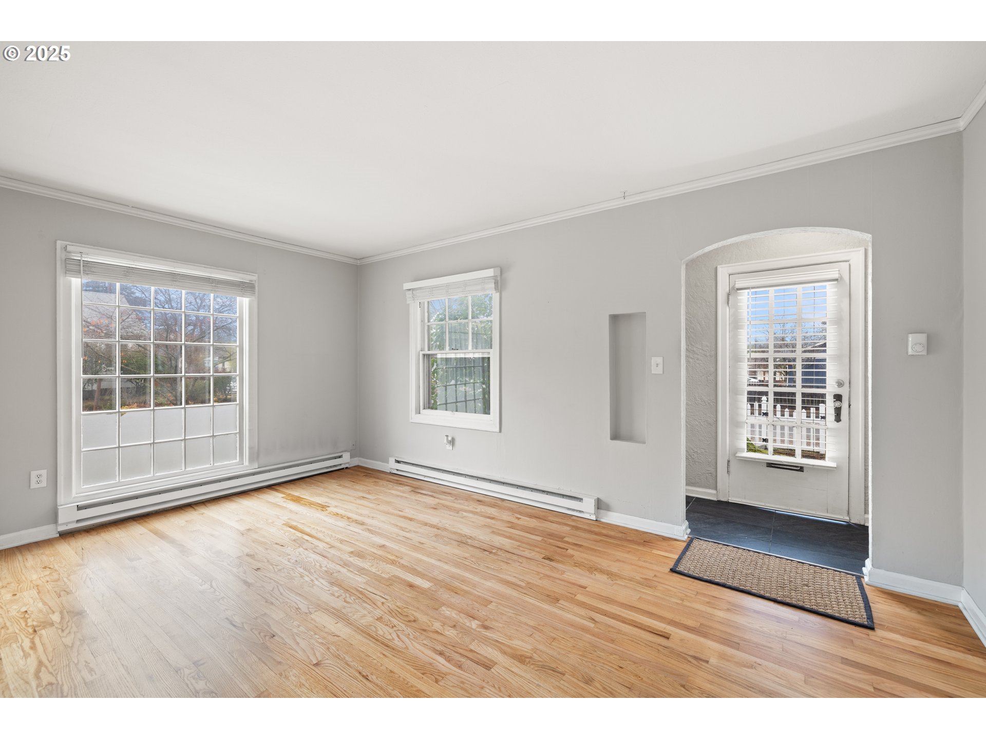 7104 Southeast Tolman Street Portland, OR 97206 - Photo 7 of 34 an empty room with wooden floor and windows