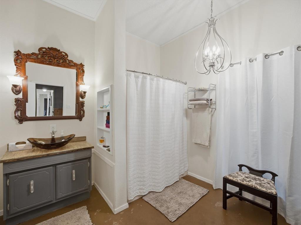 907 4th Street Graham, TX 76450 - Photo 15 of 34 a bathroom with a sink and a mirror