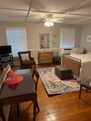 a living room with furniture and a wooden floor