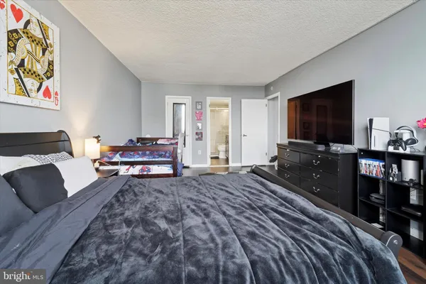 a bedroom with a bed and flat screen tv