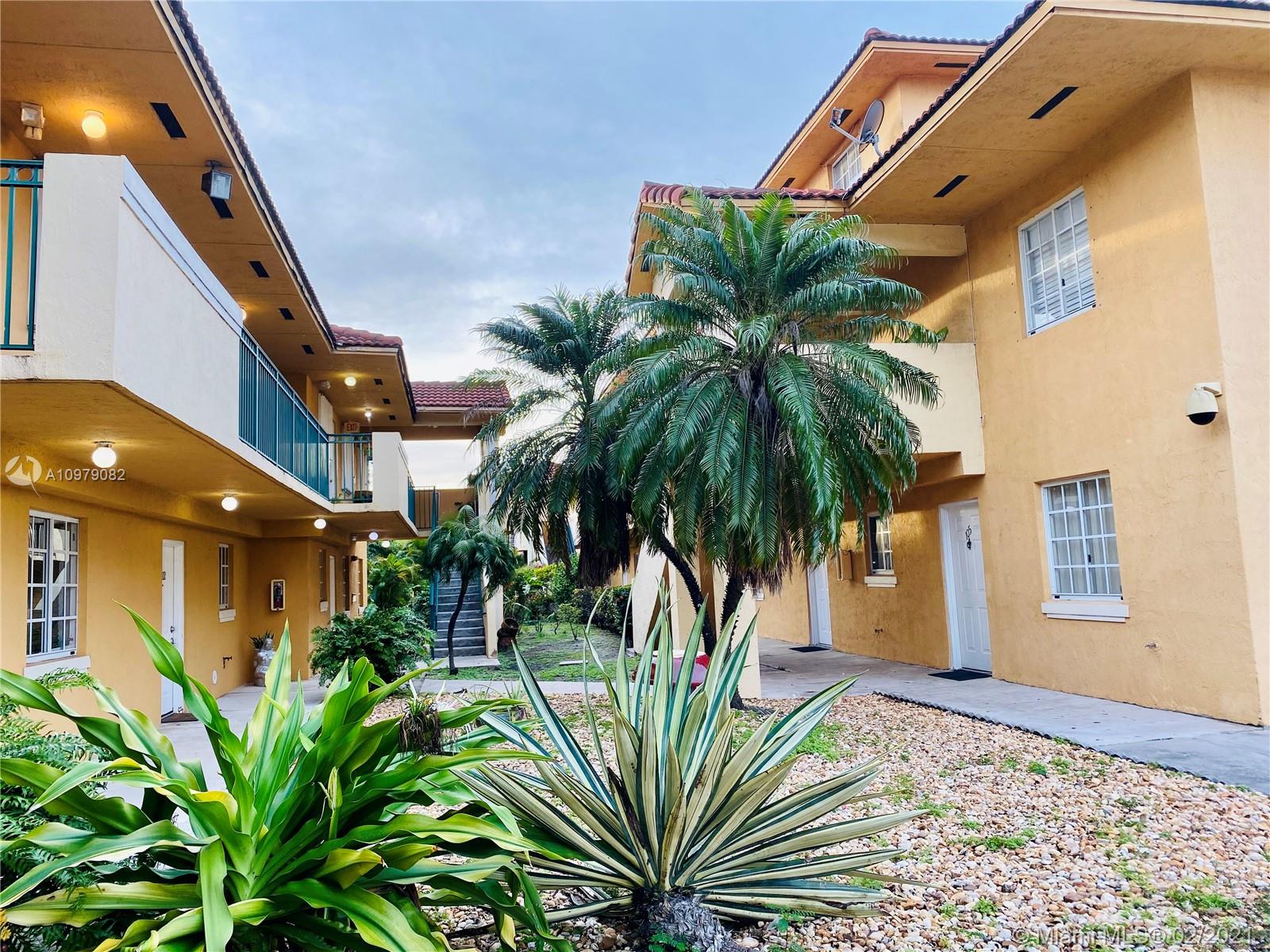 8340 Northwest 103rd Street, Unit 205D Hialeah Gardens, FL 33016 - Photo 3 of 10 a view of a palm plant that is in front of a building