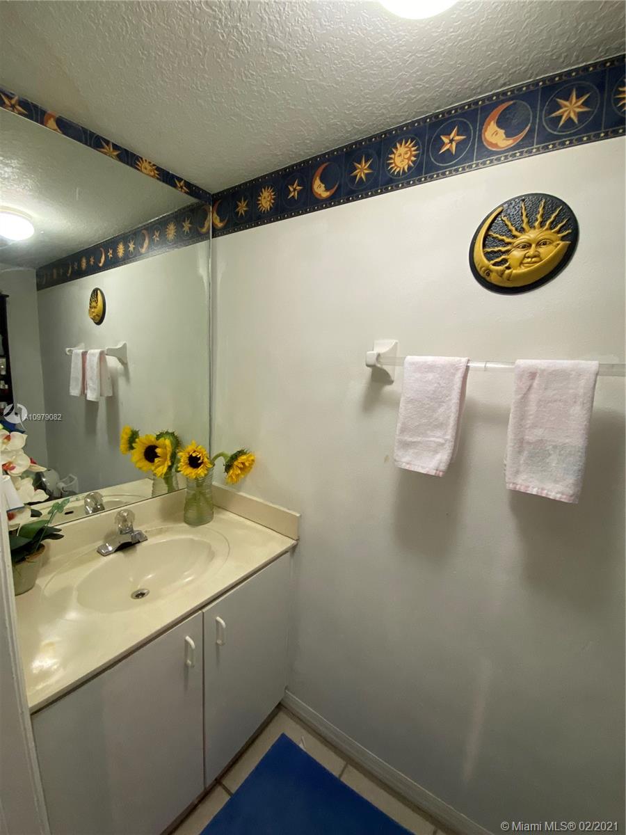 8340 Northwest 103rd Street, Unit 205D Hialeah Gardens, FL 33016 - Photo 6 of 10 a bathroom with a sink and a mirror