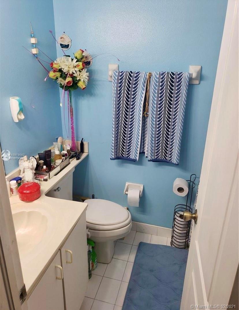 8340 Northwest 103rd Street, Unit 205D Hialeah Gardens, FL 33016 - Photo 8 of 10 a bathroom with a sink toilet and mirror