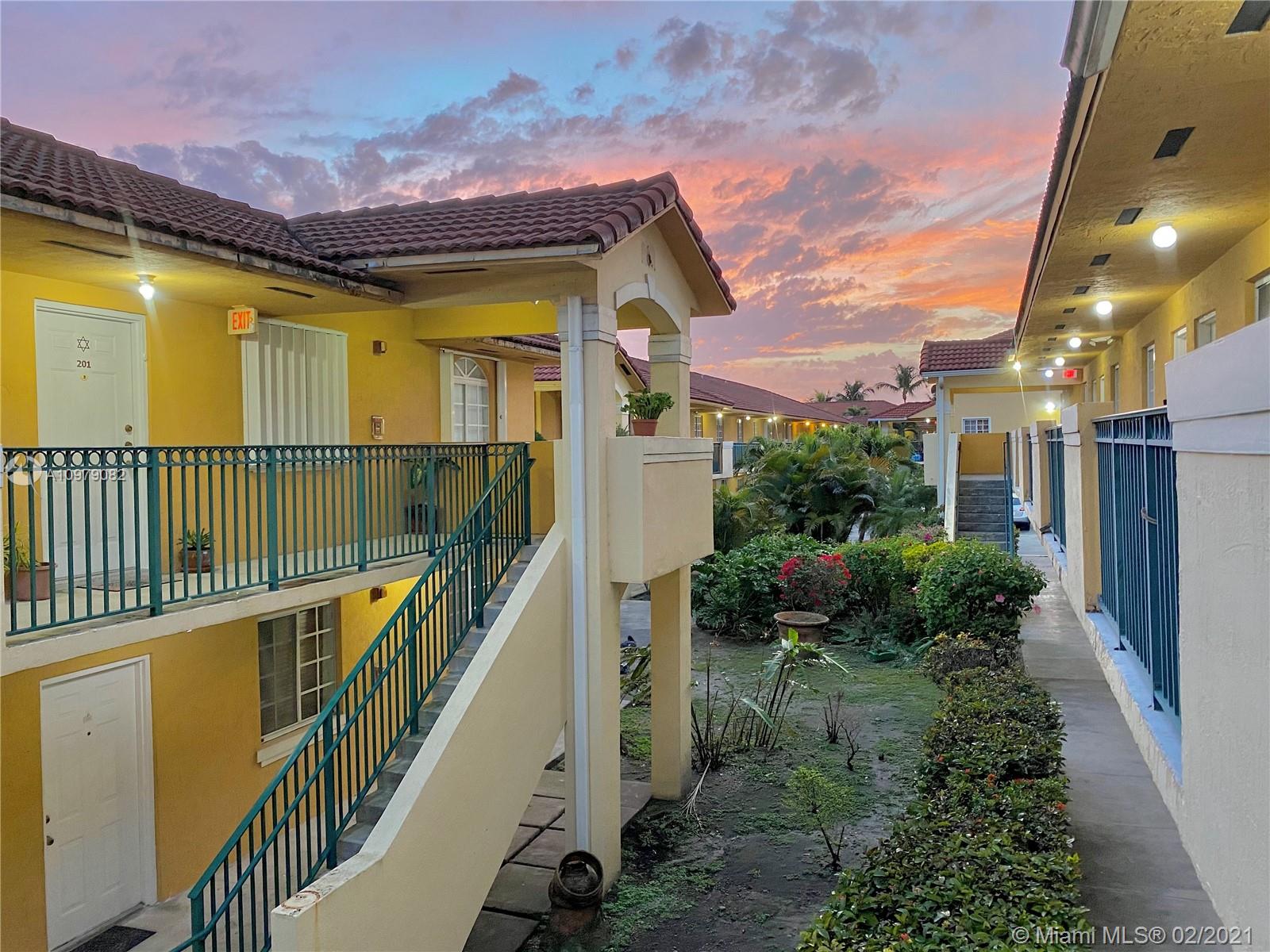 8340 Northwest 103rd Street, Unit 205D Hialeah Gardens, FL 33016 - Photo 9 of 10 a view of a house with wooden fence