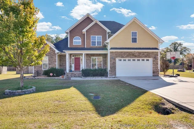 a front view of a house with a yard and garage