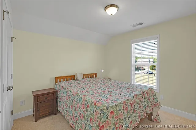 a bathroom with a granite countertop toilet sink and a mirror