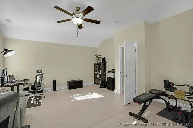 a view of a livingroom with workspace and a couch