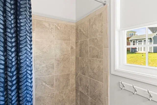 a bathroom with a window and a shower