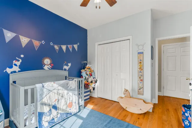 a bedroom with furniture and wooden floor