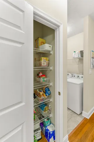 a view of storage and utility room with washer and dryer