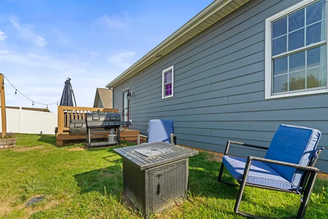 a view of a chairs and table in backyard of the house