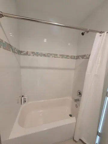 a bathroom with a shower and a bath tub