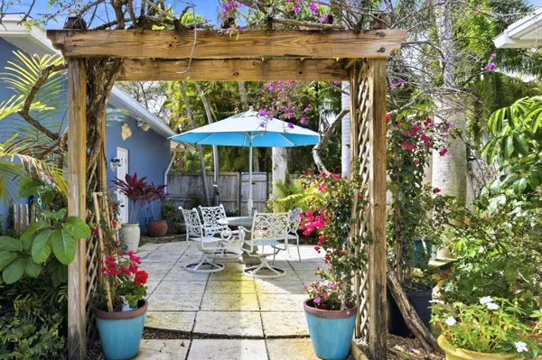 a view of a patio with chairs and potted plants