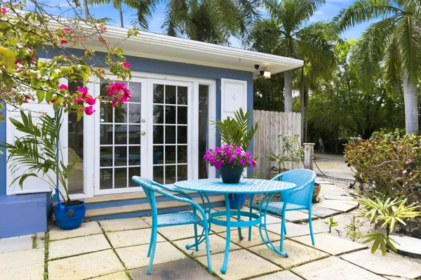 a patio with a patio table and chairs under an umbrella