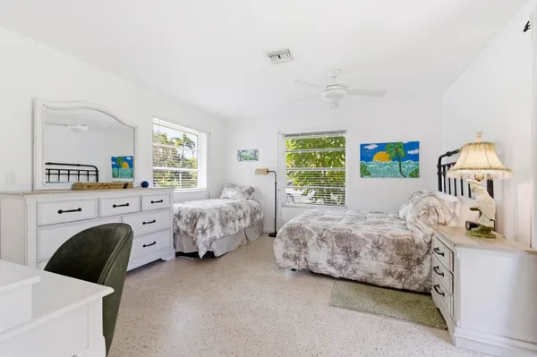 a living room with furniture and a painting on the wall